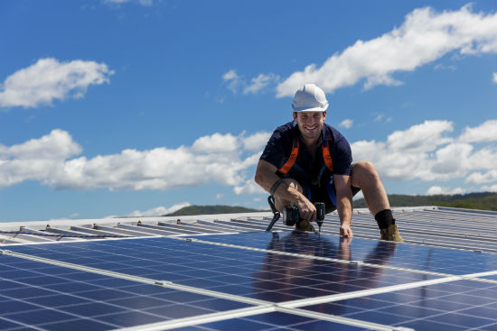 man installing solar panels